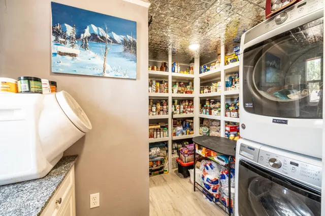 a kitchen with stainless steel appliances granite countertop a sink a stove and cabinets