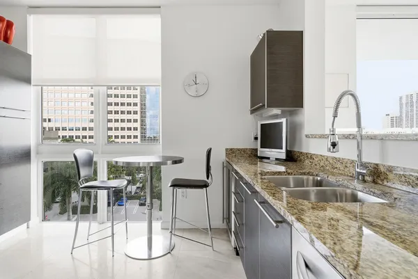 a kitchen with a counter space a sink and a stove