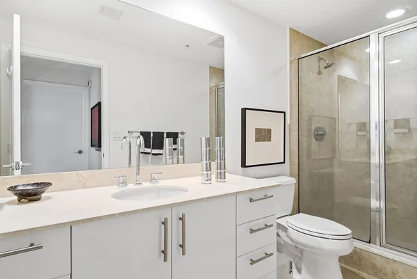 a bathroom with a sink toilet and shower