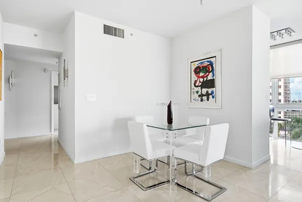 a view of a hallway with table and chair