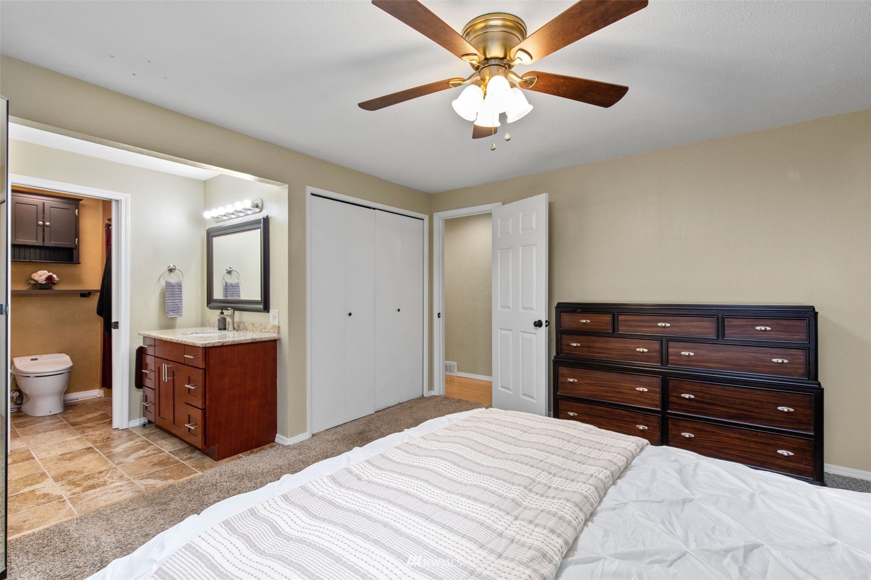 819 Duchess Road Bothell, WA 98012 - Photo 21 of 40 a bedroom with a bed and a chandelier