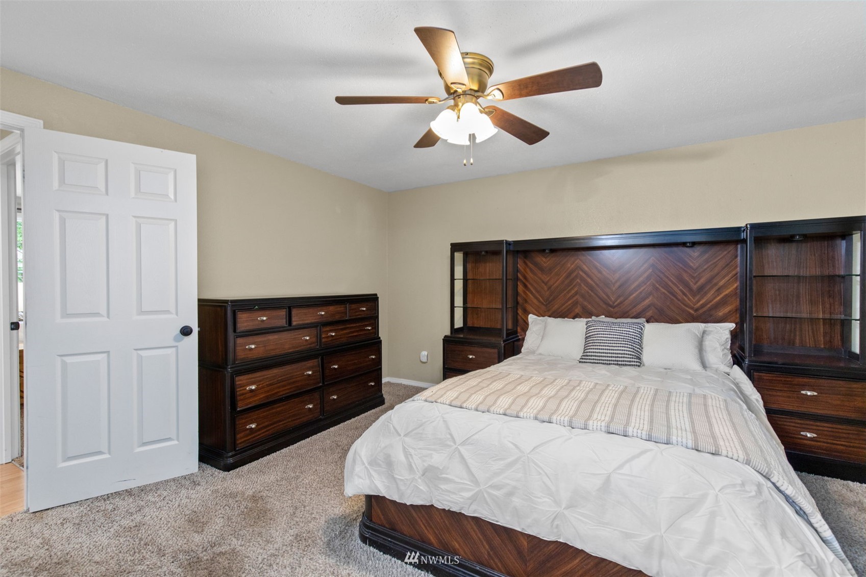 819 Duchess Road Bothell, WA 98012 - Photo 22 of 40 a bedroom with a bed and a ceiling fan
