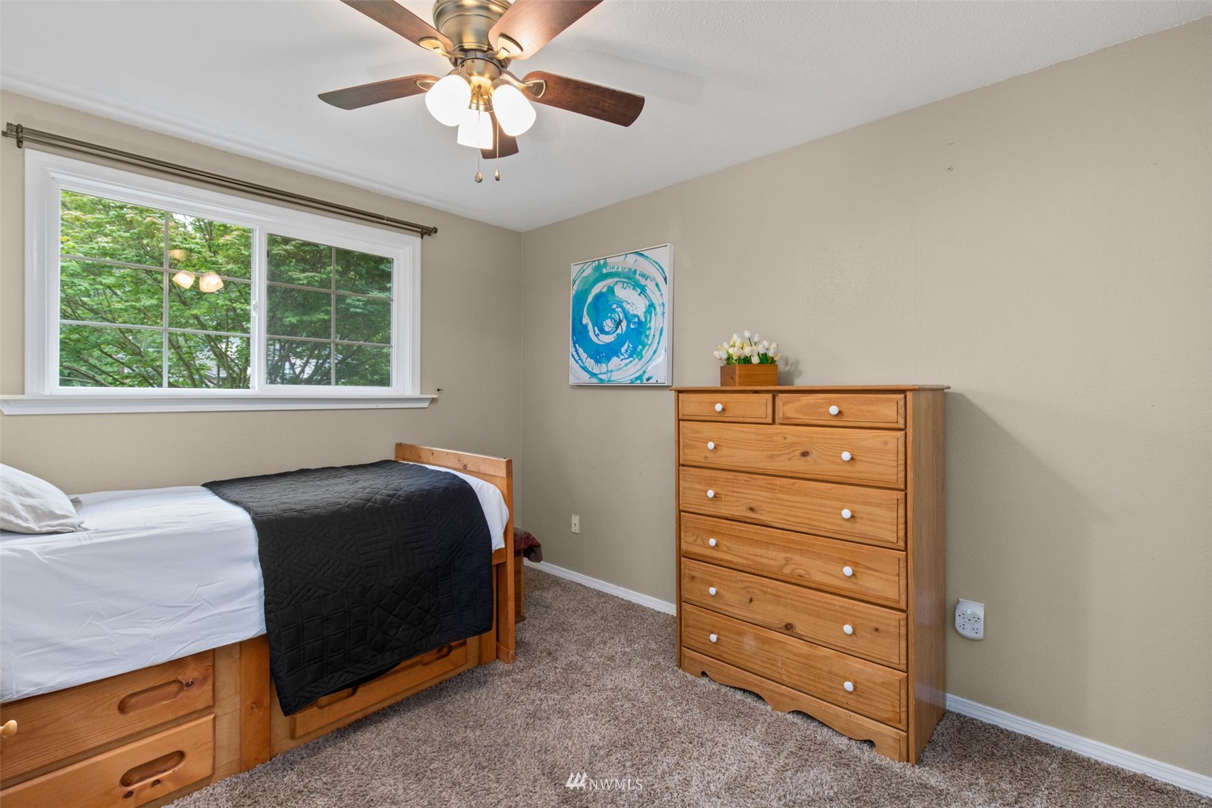819 Duchess Road Bothell, WA 98012 - Photo 25 of 40 a bedroom with a bed and a dresser