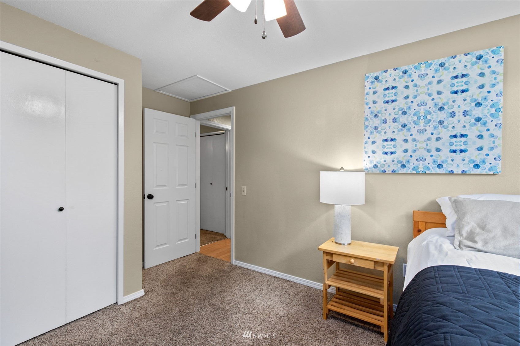 819 Duchess Road Bothell, WA 98012 - Photo 27 of 40 a bedroom with furniture and a lamp