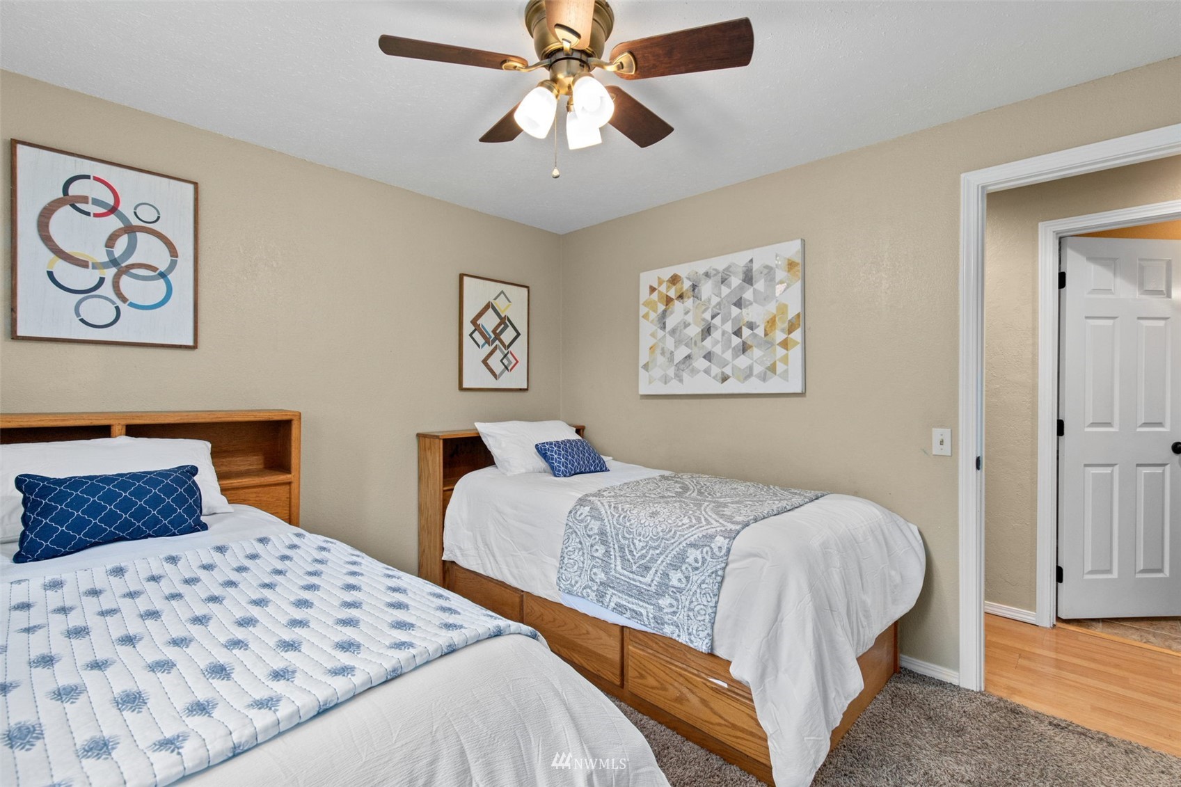 819 Duchess Road Bothell, WA 98012 - Photo 29 of 40 a bedroom with a large bed and a chandelier