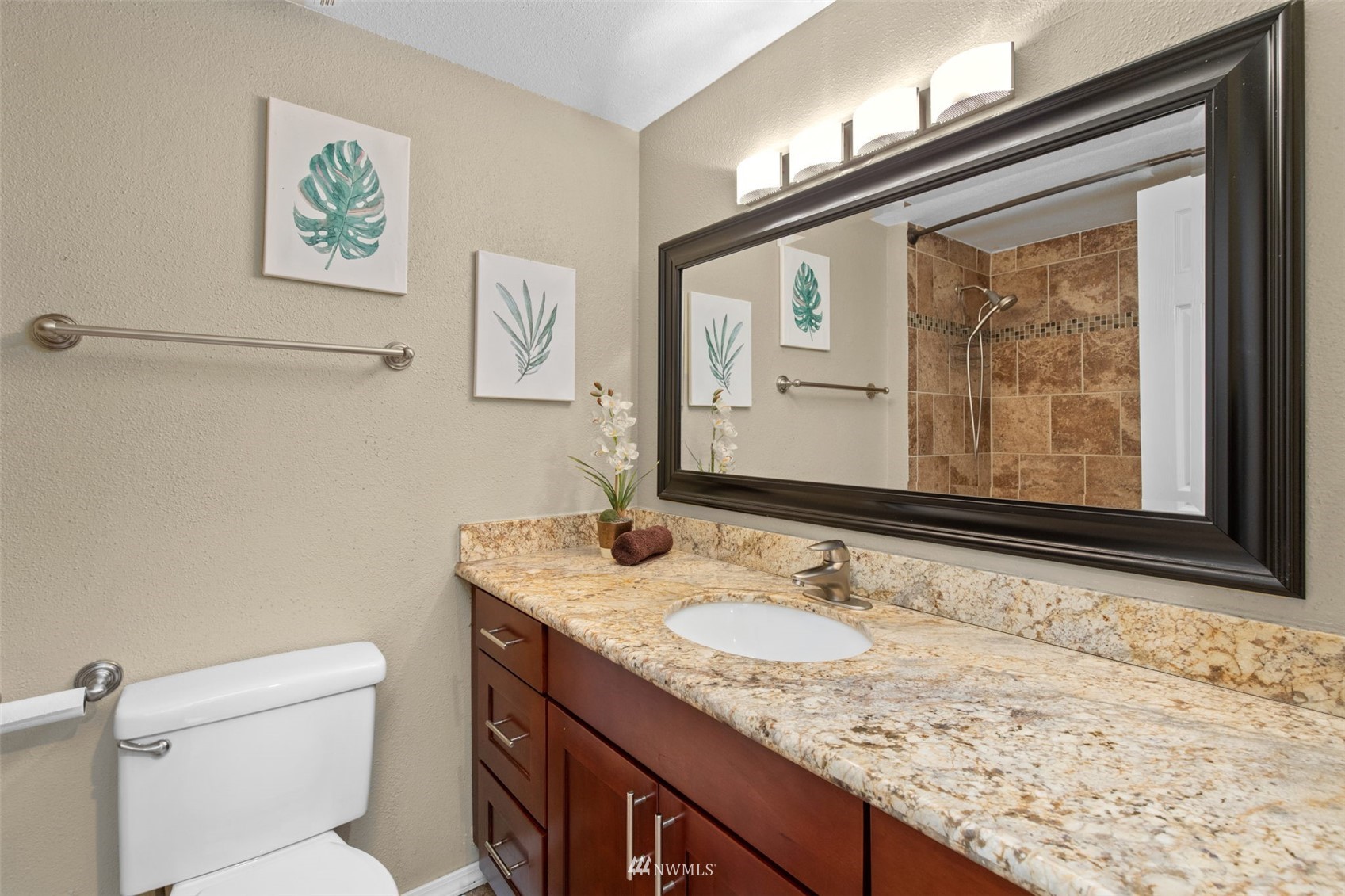 819 Duchess Road Bothell, WA 98012 - Photo 31 of 40 a bathroom with a granite countertop sink a mirror and a toilet