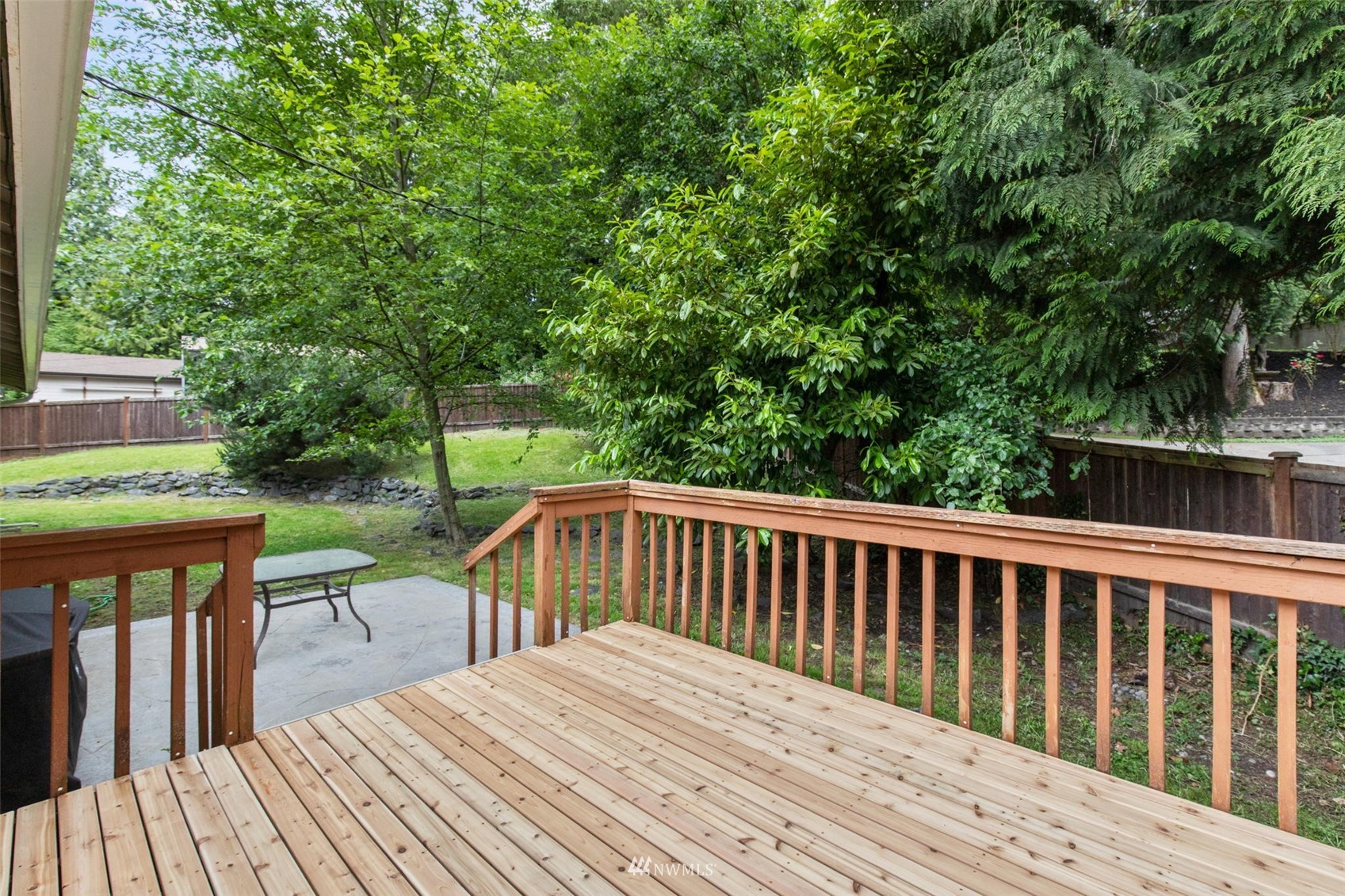 819 Duchess Road Bothell, WA 98012 - Photo 32 of 40 a view of backyard with deck and trees