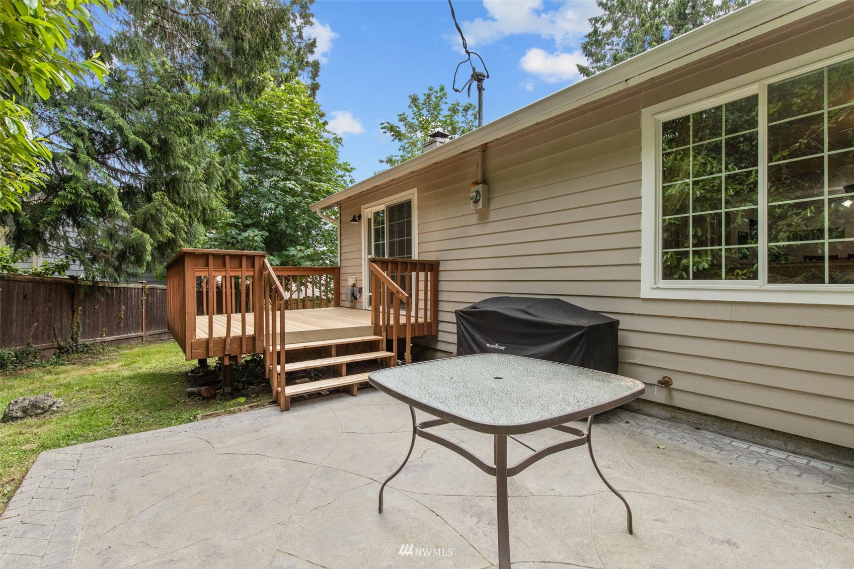 819 Duchess Road Bothell, WA 98012 - Photo 34 of 40 a view of backyard with a deck and furniture