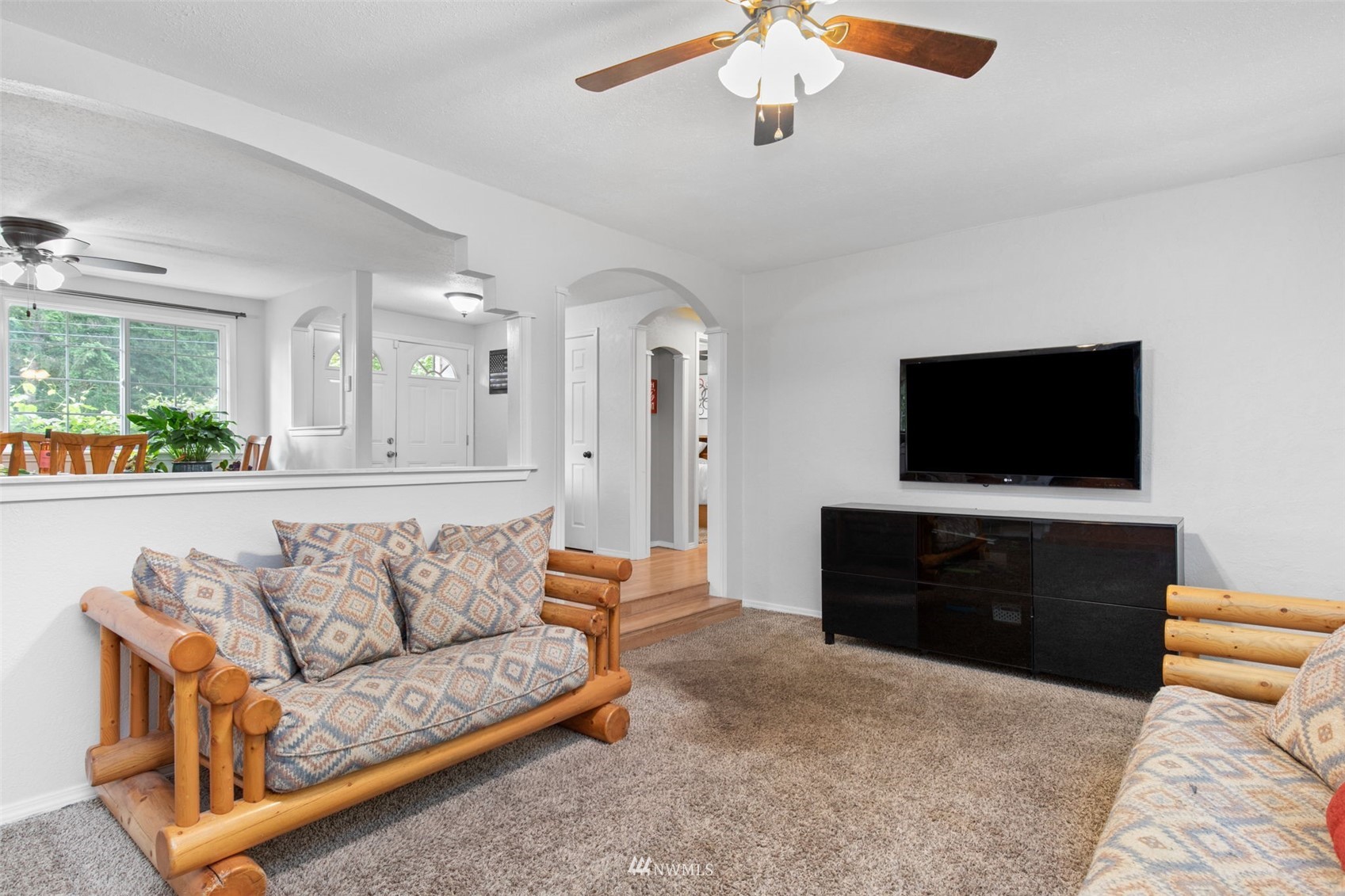 819 Duchess Road Bothell, WA 98012 - Photo 4 of 40 a living room with furniture and a flat screen tv
