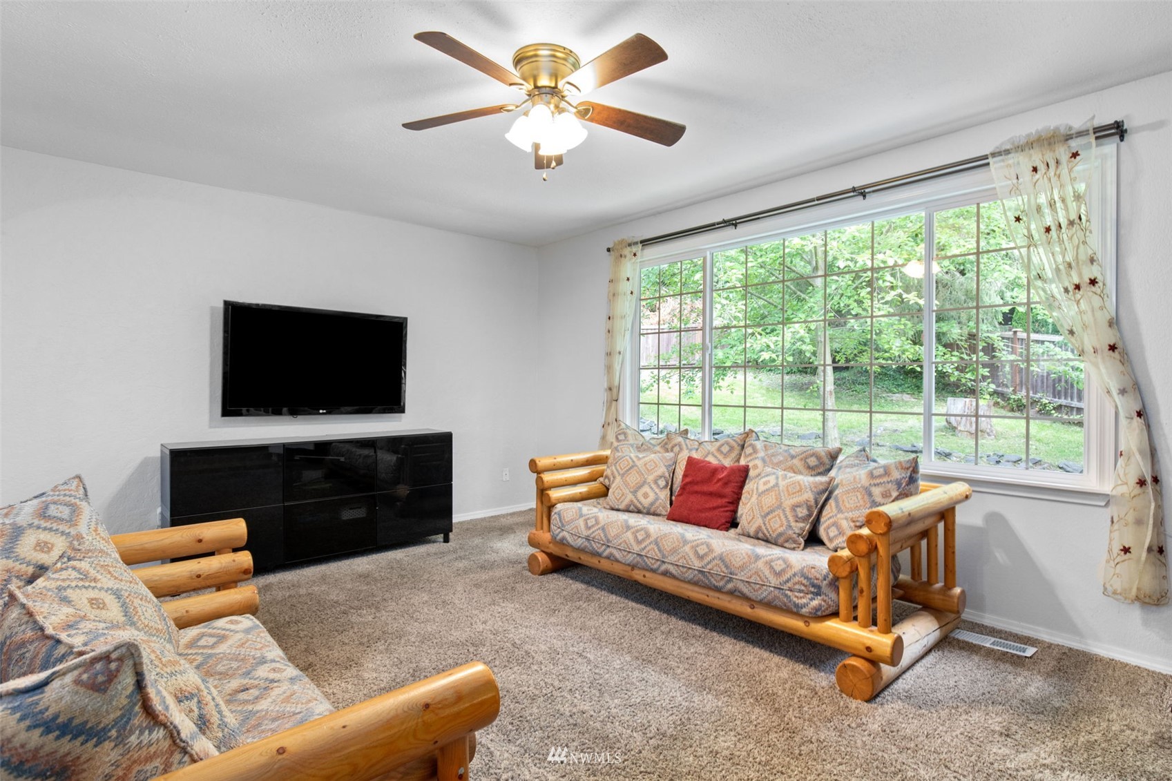819 Duchess Road Bothell, WA 98012 - Photo 5 of 40 a living room with furniture and a flat screen tv