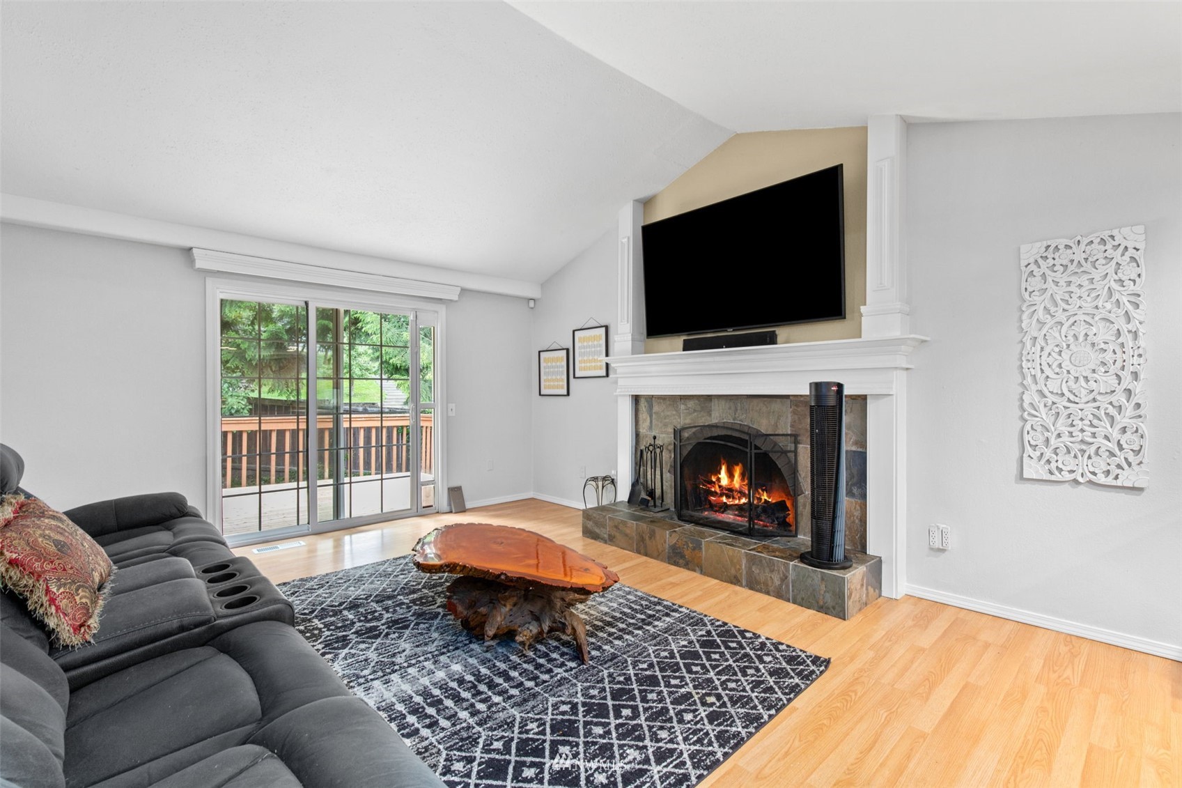 819 Duchess Road Bothell, WA 98012 - Photo 8 of 40 a living room with furniture a flat screen tv and a fireplace