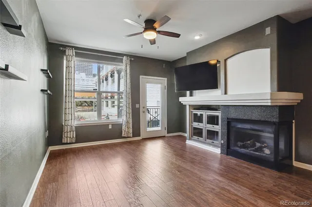 a view of a livingroom with a fireplace and window