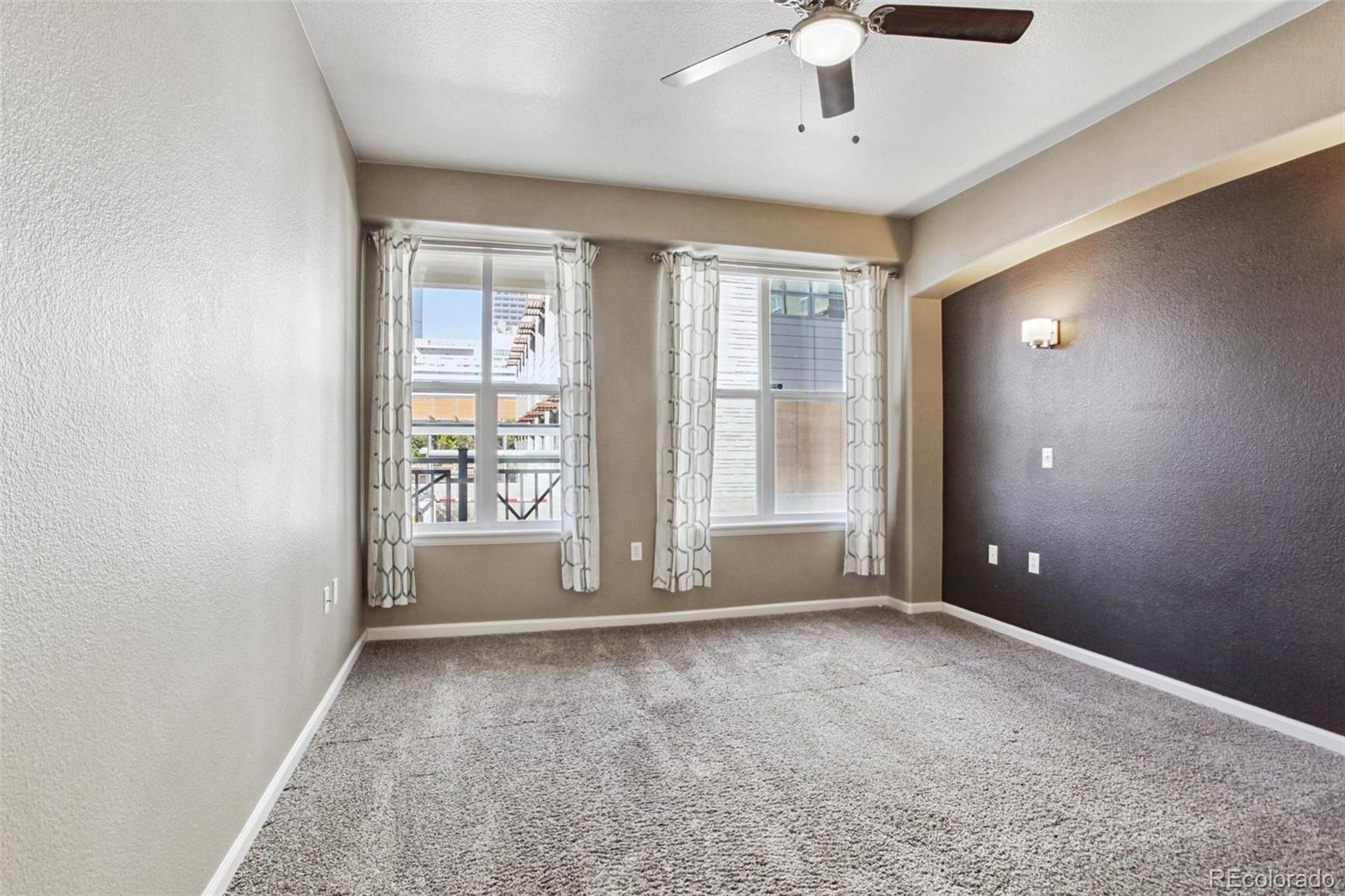 1747 Pearl Street, Unit 106 Denver, CO 80203 - Photo 13 of 26 a view of an empty room with a window