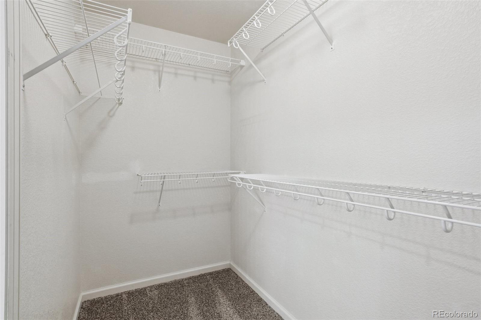 1747 Pearl Street, Unit 106 Denver, CO 80203 - Photo 18 of 26 a view of a room with racks on the wall