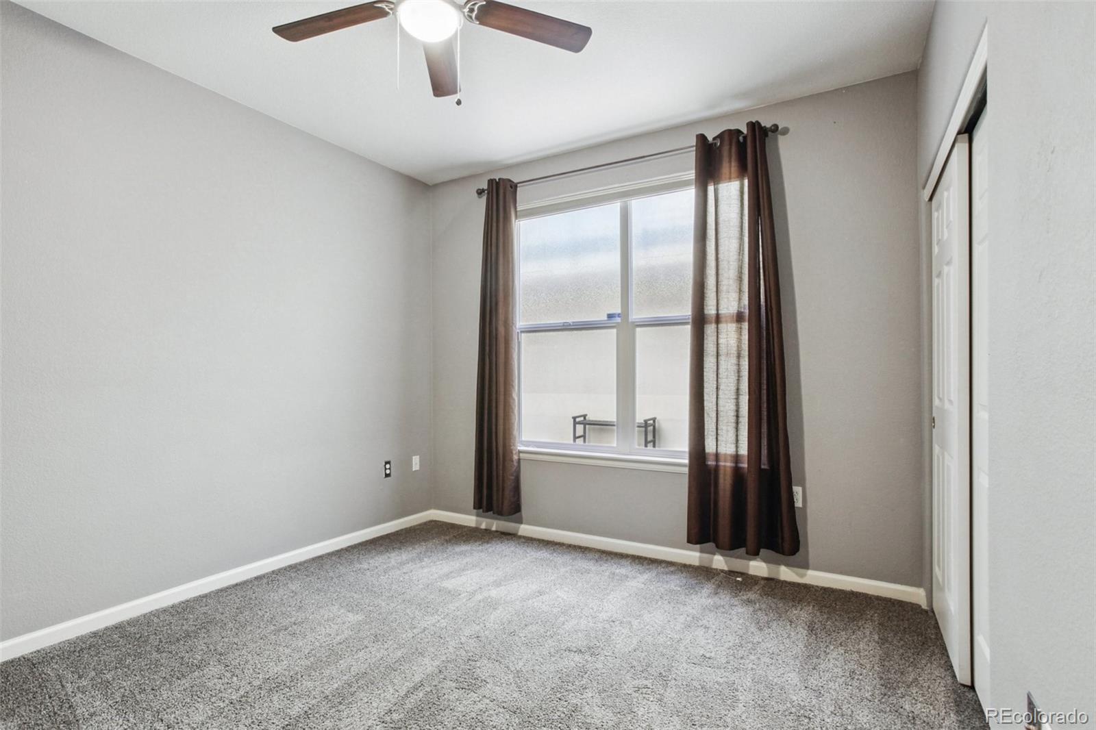 1747 Pearl Street, Unit 106 Denver, CO 80203 - Photo 19 of 26 an empty room with windows and ceiling fan