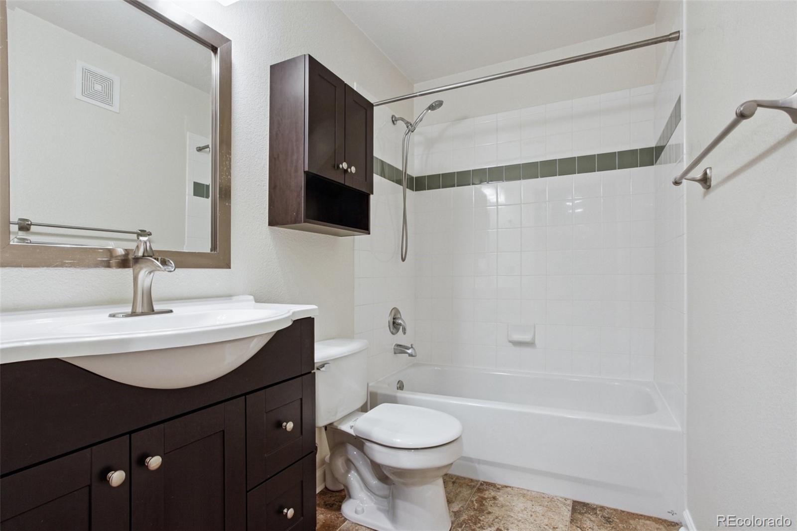 1747 Pearl Street, Unit 106 Denver, CO 80203 - Photo 20 of 26 a bathroom with a sink a toilet and a mirror