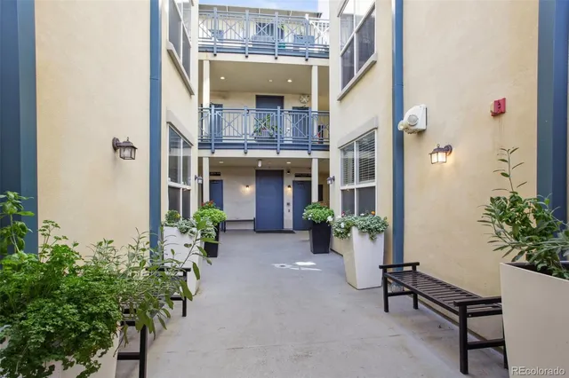 a view of an entryway with a flower pot and table