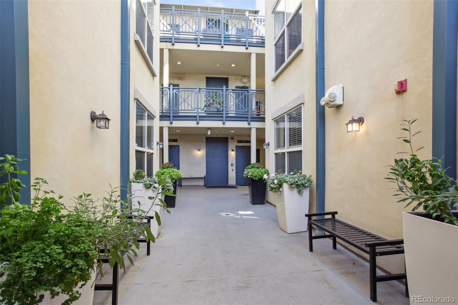 1747 Pearl Street, Unit 106 Denver, CO 80203 - Photo 3 of 26 a view of an entryway with a flower pot and table