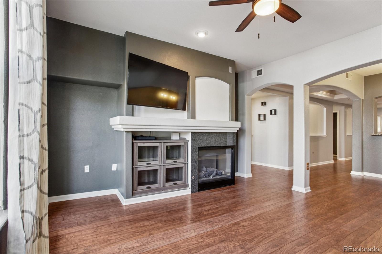 1747 Pearl Street, Unit 106 Denver, CO 80203 - Photo 10 of 26 a view of an empty room with window and wooden floor