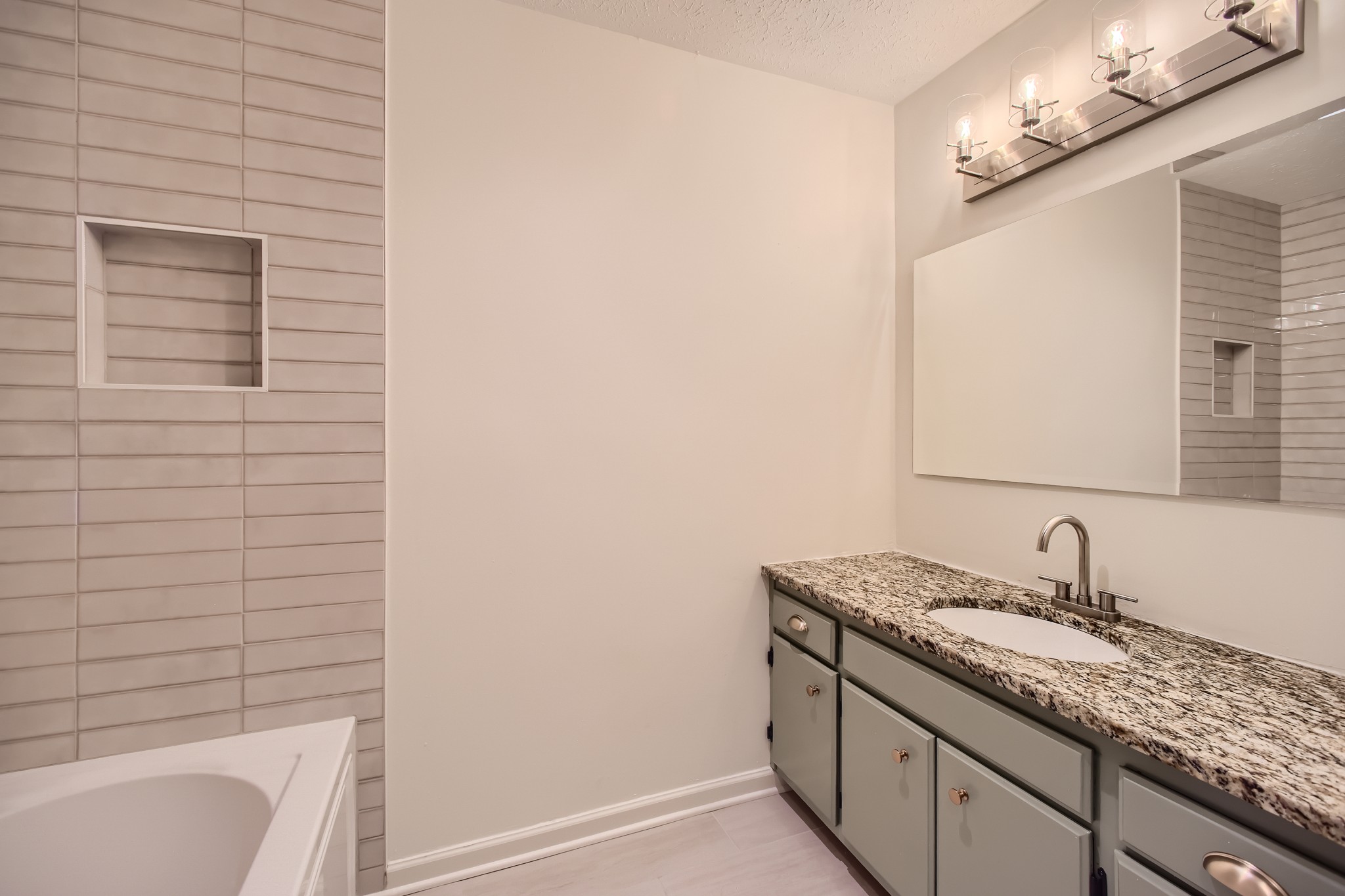 417 Hill Road Nashville, TN 37027 - Photo 14 of 27 a bathroom with a granite countertop sink and a bathtub