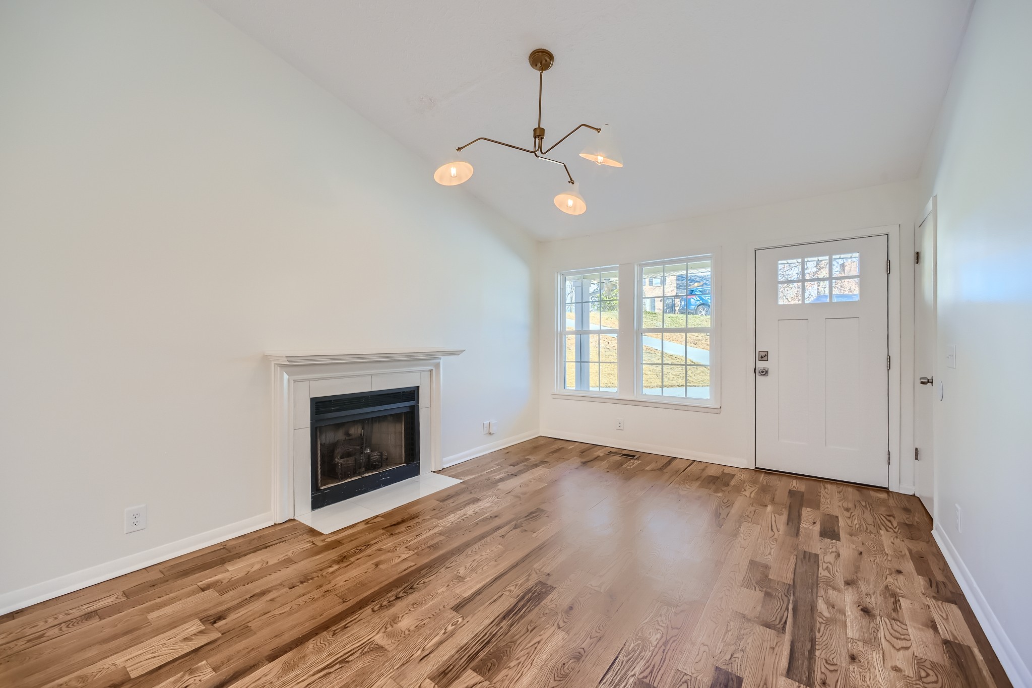 417 Hill Road Nashville, TN 37027 - Photo 5 of 27 an empty room with wooden floor fan and windows