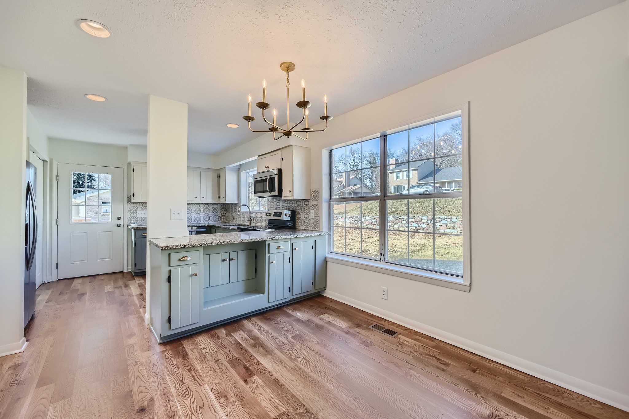 417 Hill Road Nashville, TN 37027 - Photo 7 of 27 a large kitchen with kitchen island white cabinets and stainless steel appliances