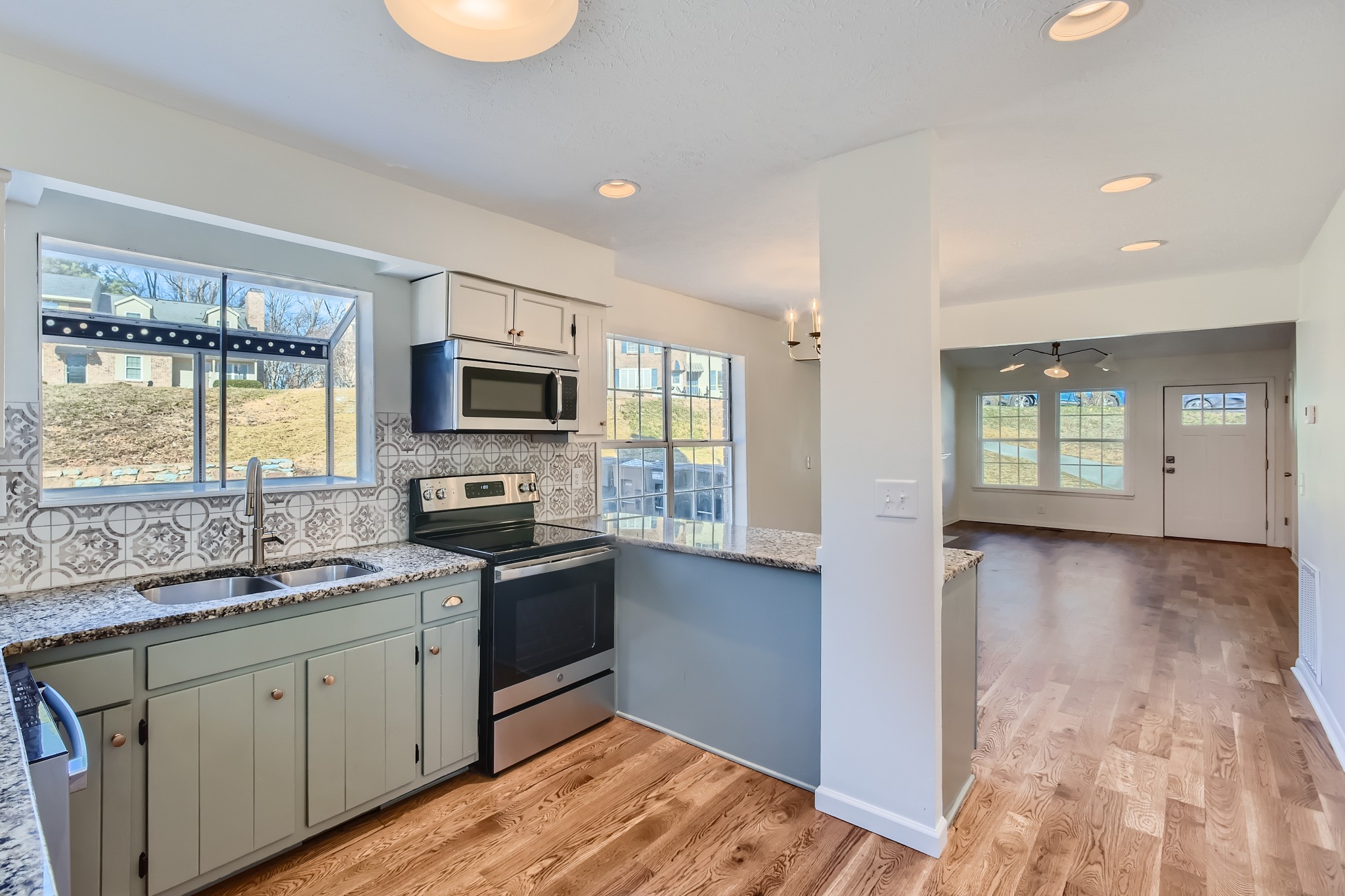 417 Hill Road Nashville, TN 37027 - Photo 9 of 27 a kitchen with stainless steel appliances granite countertop a stove a sink and a microwave
