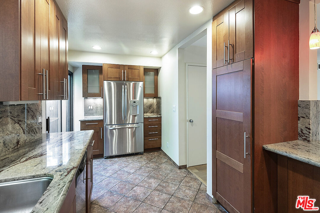 2216 South Bentley Avenue, Unit 10 Los Angeles, CA 90064 - Photo 15 of 40 a kitchen with stainless steel appliances granite countertop a refrigerator and a stove