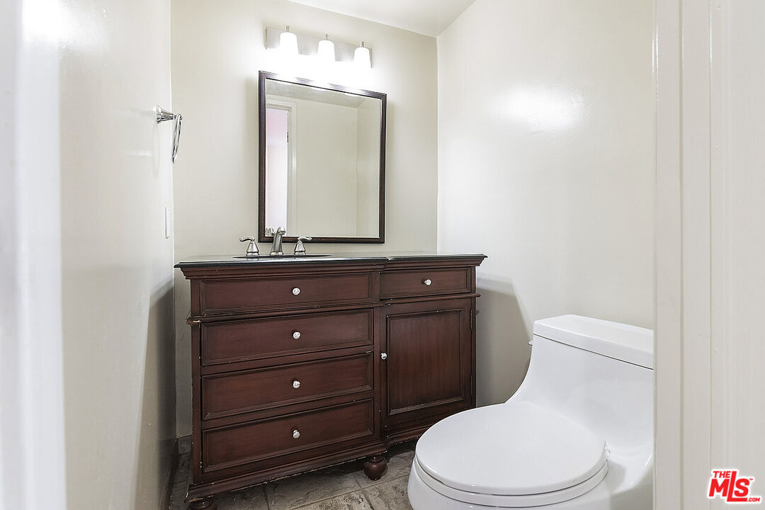 2216 South Bentley Avenue, Unit 10 Los Angeles, CA 90064 - Photo 16 of 40 a bathroom with a toilet mirror vanity and vanity