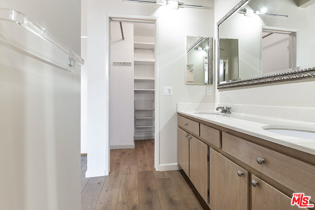 2216 South Bentley Avenue, Unit 10 Los Angeles, CA 90064 - Photo 23 of 40 a bathroom with a double vanity sink a mirror and a shower