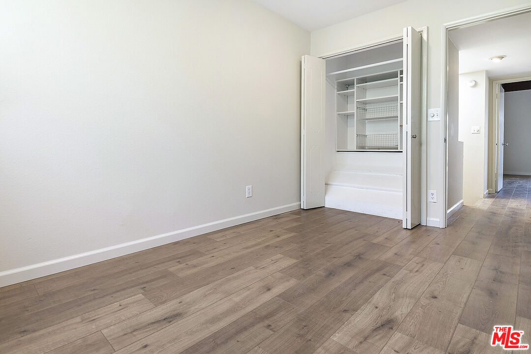 2216 South Bentley Avenue, Unit 10 Los Angeles, CA 90064 - Photo 32 of 40 a view of an empty room with wooden floor and closet
