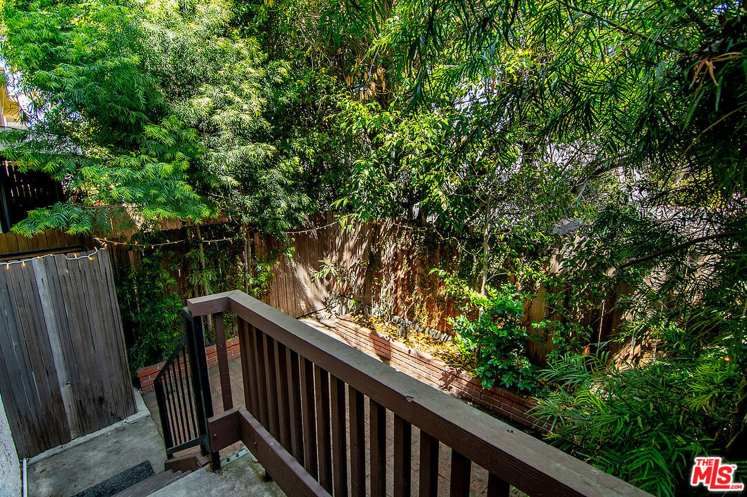 2216 South Bentley Avenue, Unit 10 Los Angeles, CA 90064 - Photo 36 of 40 a view of balcony with wooden fence and trees