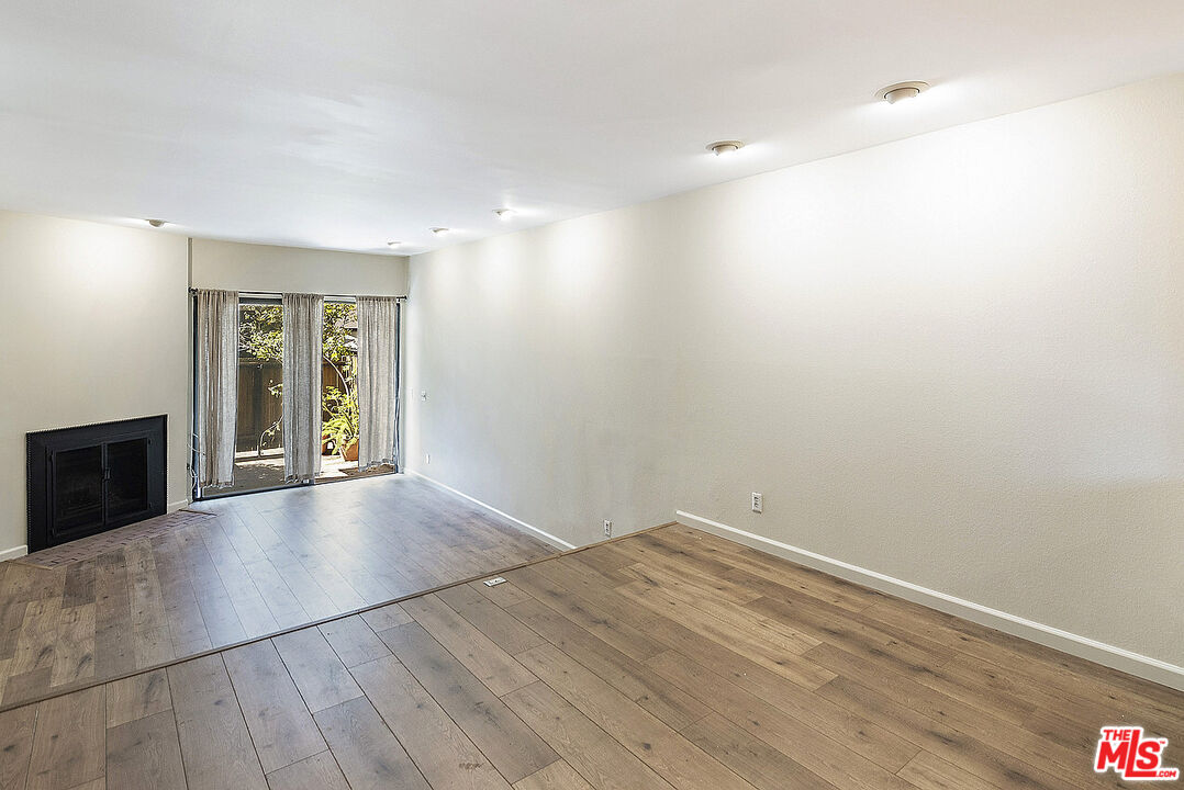 2216 South Bentley Avenue, Unit 10 Los Angeles, CA 90064 - Photo 9 of 40 wooden floor in an empty room with a window