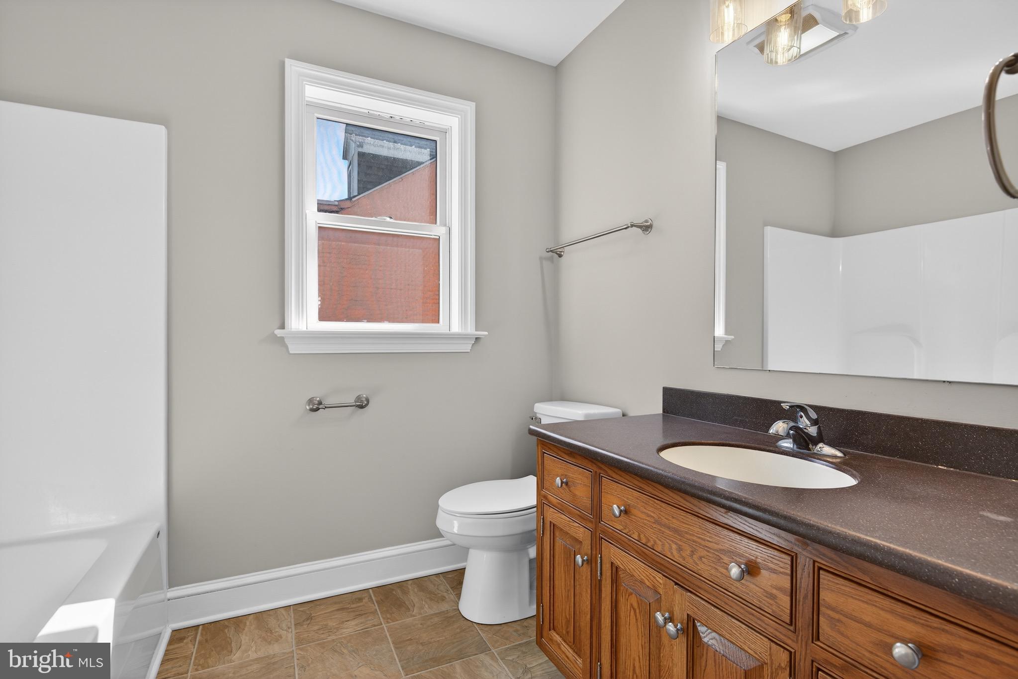 637 East Fulton Street Lancaster, PA 17602 - Photo 18 of 28 a bathroom with a sink a toilet and mirror