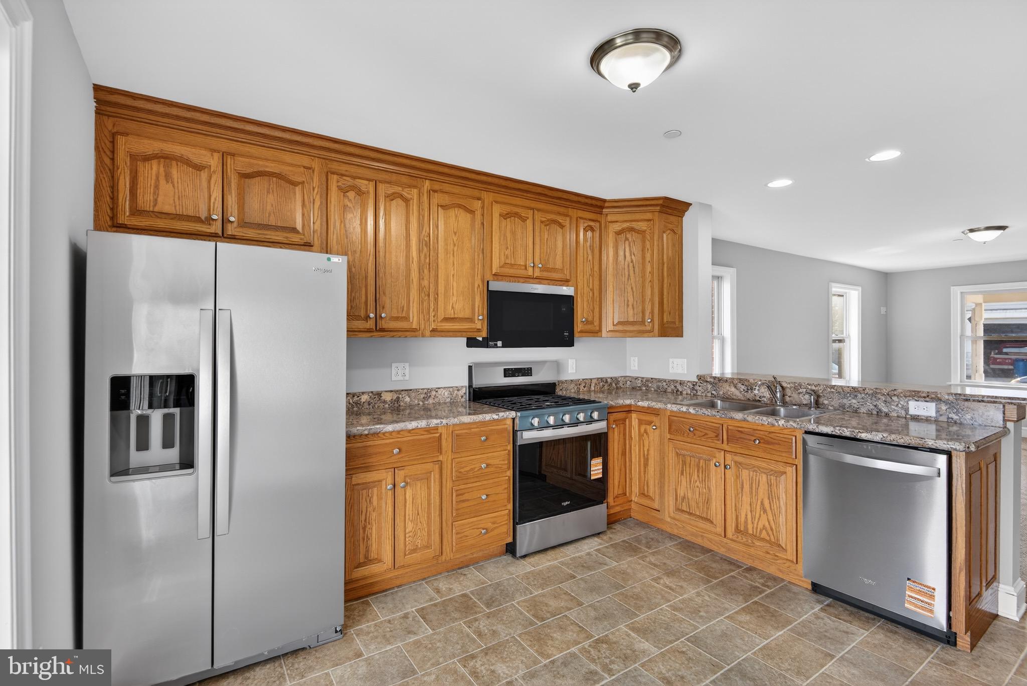 637 East Fulton Street Lancaster, PA 17602 - Photo 9 of 28 a kitchen with stainless steel appliances granite countertop a refrigerator stove microwave and sink