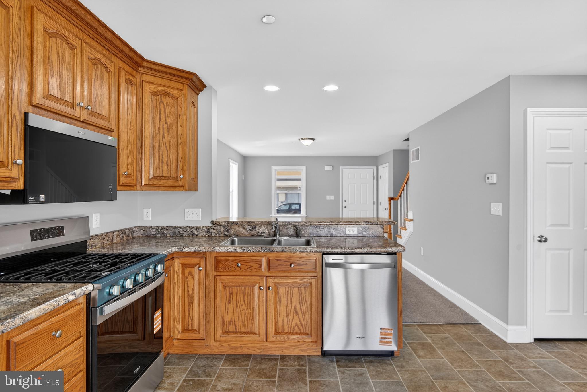 637 East Fulton Street Lancaster, PA 17602 - Photo 10 of 28 a kitchen with stainless steel appliances granite countertop a stove a sink and a microwave