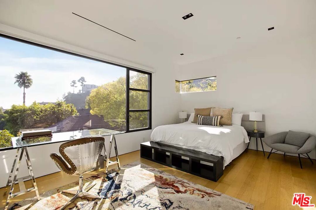 1331 Belfast Drive Los Angeles, CA 90069 - Photo 13 of 25 a large bedroom with a bed and large windows