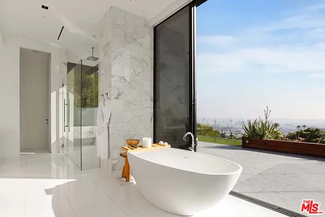 a bathroom with a bathtub and shower