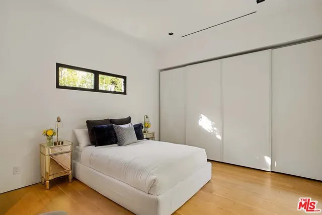 a bedroom with a bed and a wall painting