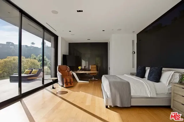 a bedroom with bed and glass door