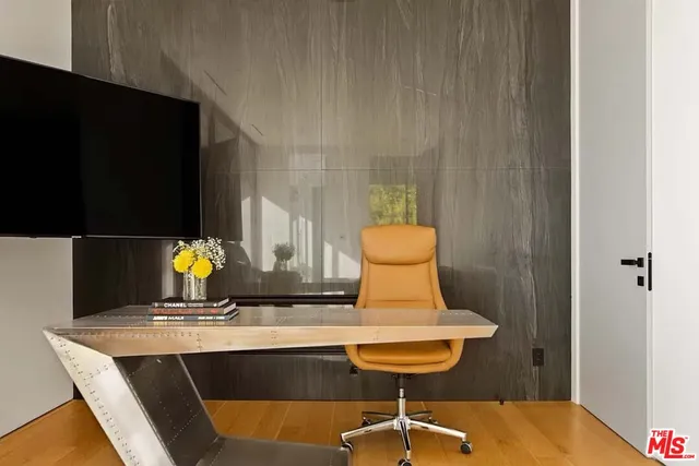 a view of bathroom with a sink and wooden cabinet