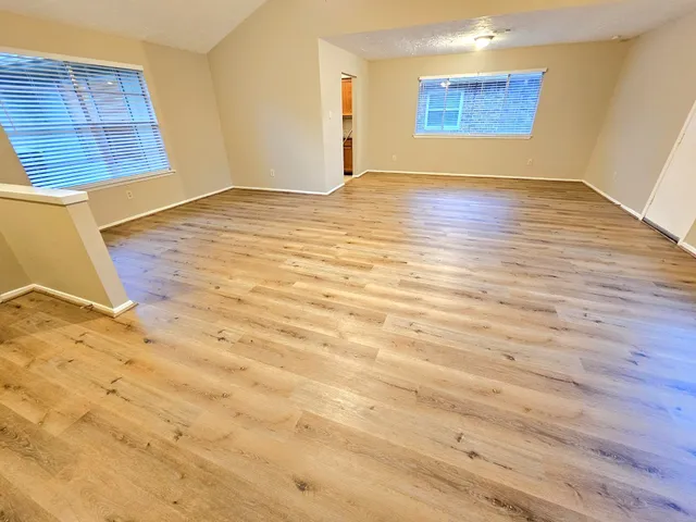 a view of an empty room and wooden floor