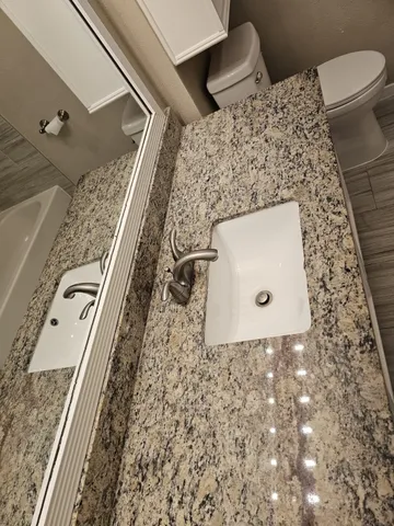 a bathroom with a toilet and a sink