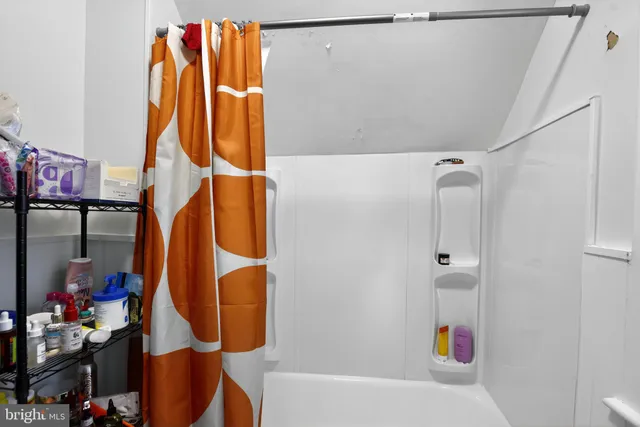 a bathroom with a bathtub and shower