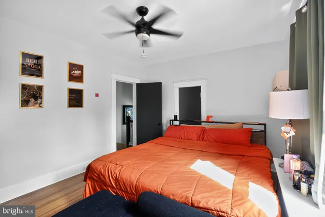 a bedroom with a bed and a lamp on table