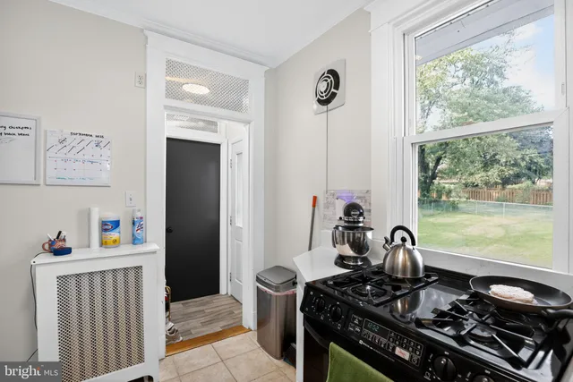 a kitchen with a stove and a wooden floor