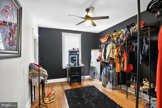 a view of a living room with clothes and shoes