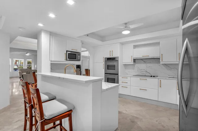 a kitchen with appliances cabinets and furniture