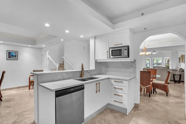 a kitchen with a sink cabinets and stainless steel appliances