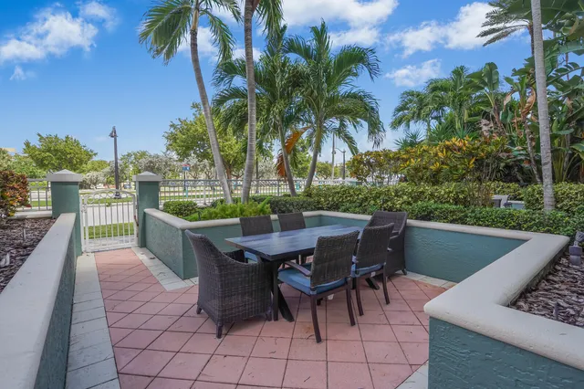 a view of a patio with table and chairs and potted plants